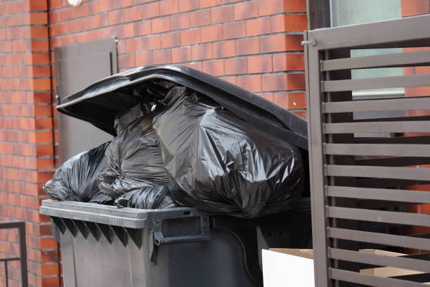 istock black plastic trash can filled with garbage bags 1472646550