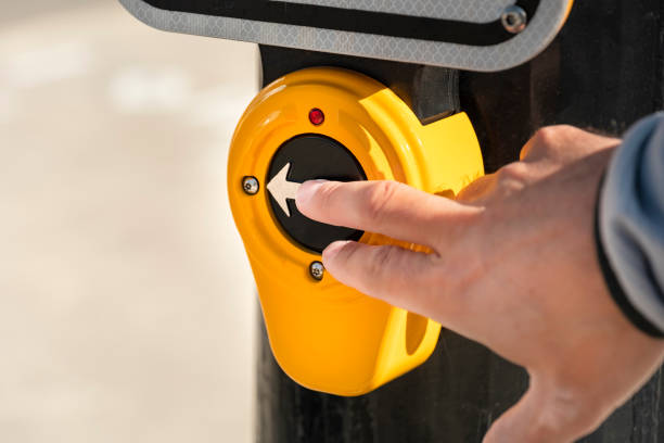 istock Man pushes a downtown street crosswalk button 1472647961