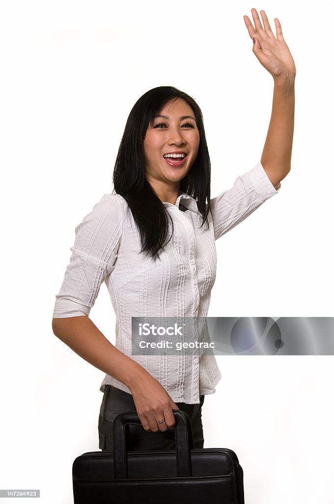 Hailing a cab Attractive Asian woman wearing white blouse and grey slacks with hand up waving carrying a briefcase Adult Stock Photo