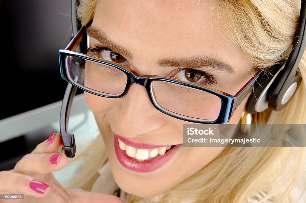 young secretary with headset close view of young secretary with headset in an  office 20-24 Years Stock Photo