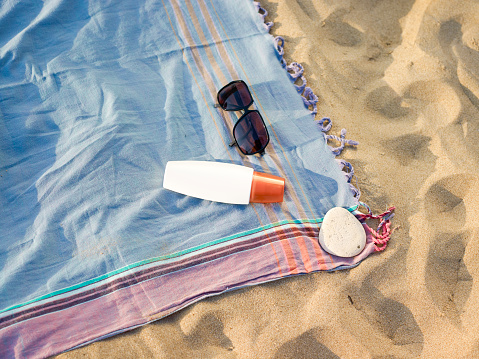 Beach towel and sun glasses