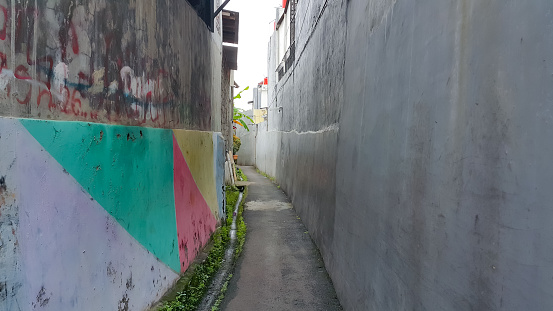 View of a small alley in a residential area in Jakarta. Clean and neat street.