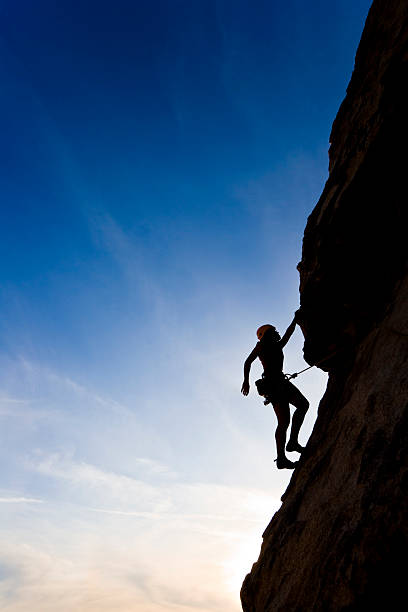 istock Rock climber clinging to a cliff. 147266060