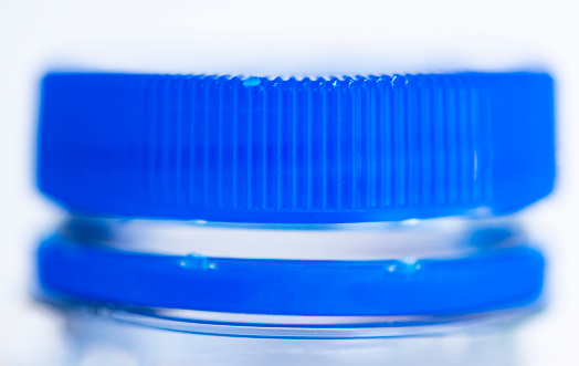 This is a close up photograph of the cap on an empty plastic water bottle.