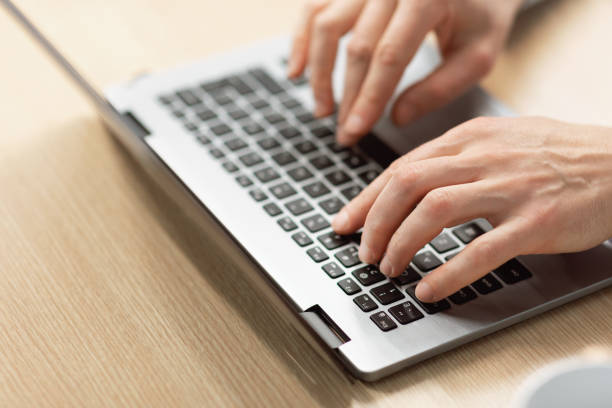 istock Business man using laptop sitting at desk in office 1472661544