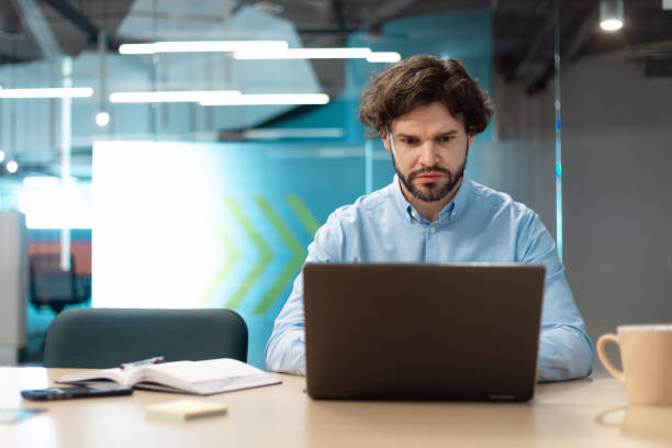 istock Business man using laptop sitting on chair in modern office 1472661558