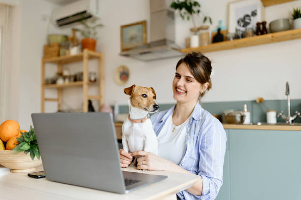 istock Smiling woman holding a dog 1472661659