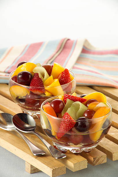 Fresh Fruit Salad on a wooden tray stock photo