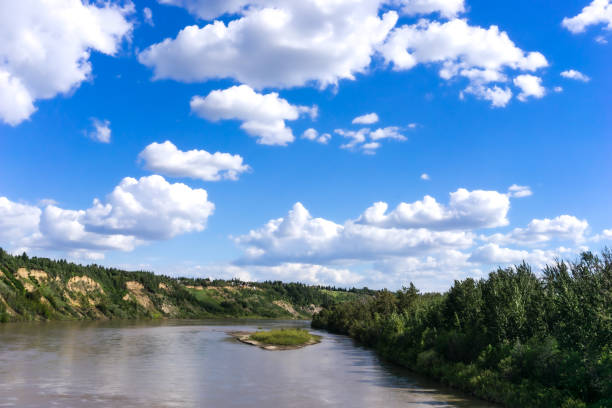 North saskatchewan river landscape in summer season with blue sky and white clouds stock photo
