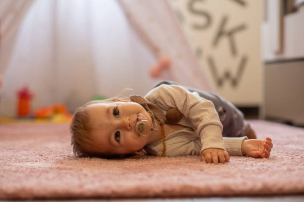 istock the baby is lying on the floor 1472666710