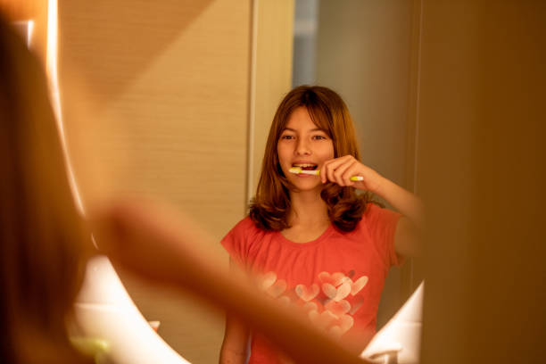 istock the little girl is brushing her teeth 1472667441