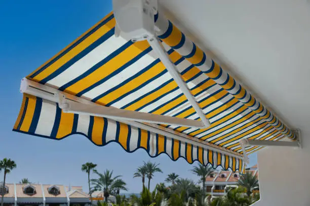 retractable manual awning above apartment balcony