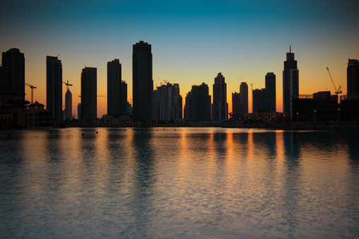 Row of residential building silhouetted at sunset in Dubai city