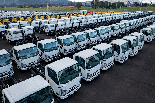 Group of trucks parked at a car dealership for sale - automobile industry concepts