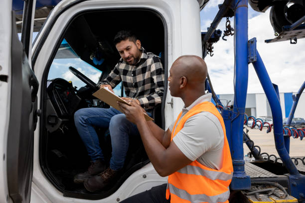 istock Truck driver talking to his supervisor at a commercial dock 1472673484