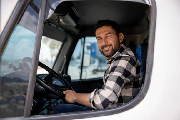 Happy truck driver smiling at the camera stock photo