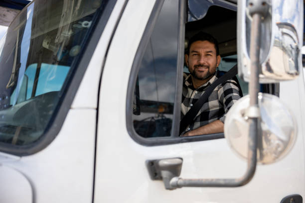 istock Truck driver driving his cargo vehicle 1472673489