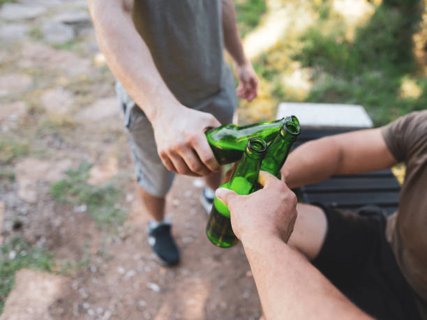 istock Two men clinking beer in nature, cheers, having a celebrating toast 1472674839