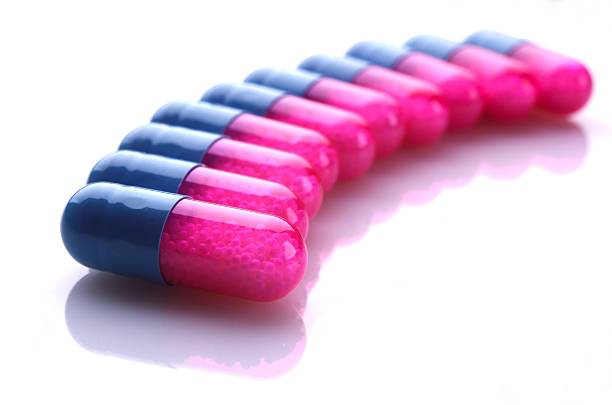 Row of blue and pink capsules stock photo