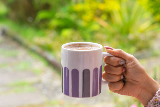 istock woman holding cup with hot drink 1472679965