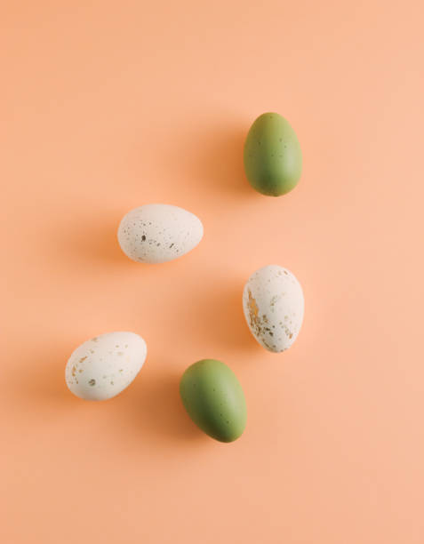 istock Easter pattern made of white and green eggs on pastel orange background. Minimal Easter holiday composition. 1472680954