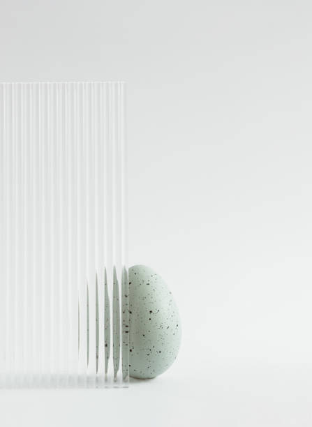 istock Modern composition made of green Easter egg on grey background. Embossed glass texture background. Minimal festive concept. Abstract Easter card. Copy space. 1472682156