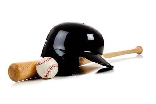 Assorted baseball equipment with a baseball bat, a ball and a batting helmet on a white background with copy space