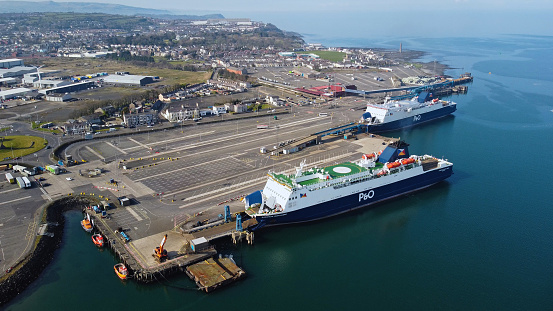 Aberdeen, UK - May 2016: A view from Nigg Bay in Aberdeen, looking over Aberdeen Harbour, with an offshore supply vessel in the foreground entering the harbour.