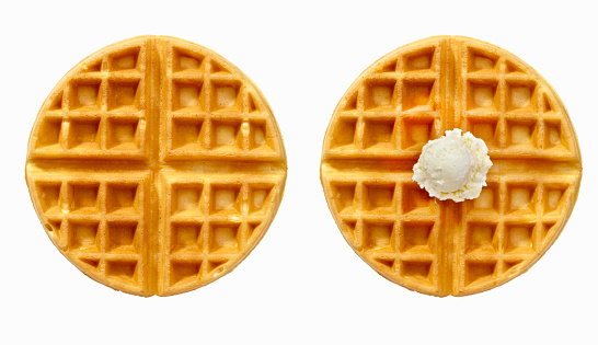 One Plain waffle and one with butter, isolated on a white background.