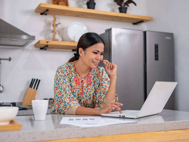 istock Woman typing something on laptop 1472689468