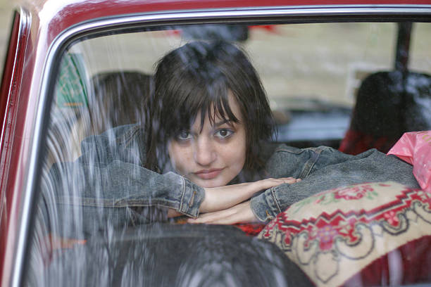 young girl in the old car
