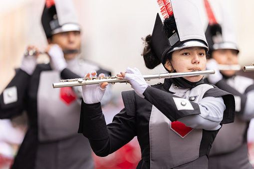 Brownsville, Texas, USA - February 26, 2022: Charro Days Grand International Parade, Members of the Rivera High School Raider Marching Band performing at the parade