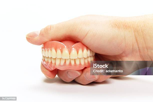 A Hand Holding A Complete Set Of Dentures Stock Photo - Download Image Now - Bridge - Built Structure, Tooth Crown, Dental Equipment