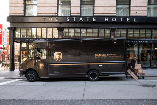 Seattle, USA - Feb 18th, 2023: A UPS truck on 2nd ave outside the State Hotel late in the day.