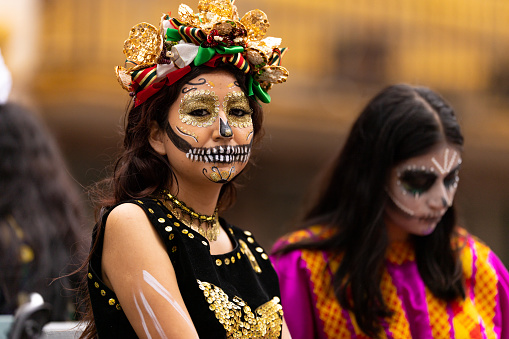 Matamoros, Tamaulipas, Mexico - November 1, 2022: Dia de los Muertos Parade, young women dressed as catrinas riding a float at the parade