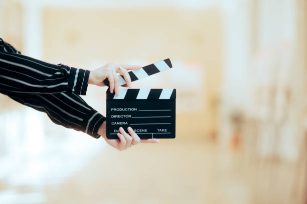 Director Holding a Film Clapper Board in a Museum Person working in creative industry doing an independent movie art and craft product stock pictures, royalty-free photos & images