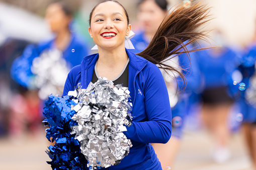 Laredo, Texas, USA - February 19, 2022: The Anheuser-Busch Washingtons Birthday Parade, The Dr. Leo. G. Cigarroa High School Cheerleaders performing at the parade