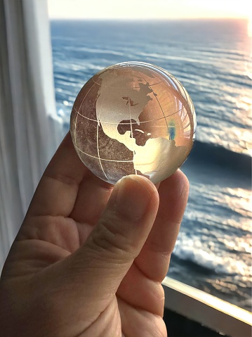Hand holding small translucent globe