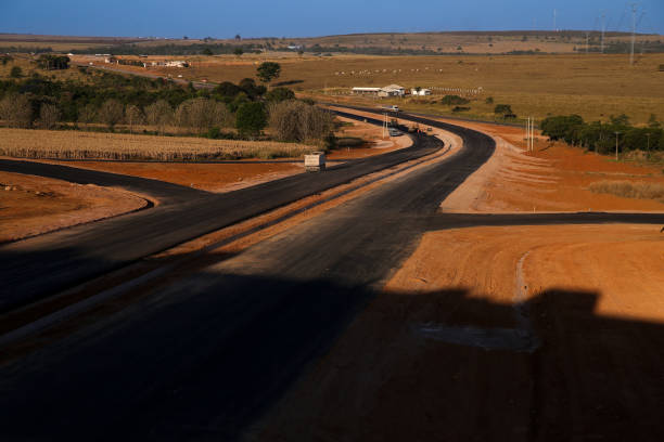istock Newly built asphalt road on blue sky day 1472713639