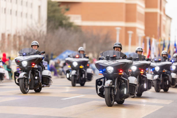 Laredo, Texas, USA - February 19, 2022: The Anheuser-Busch Washingtons Birthday Parade, Members of the Laredo Police Department riding motorcycles, waving at people