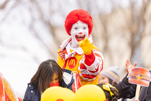 Laredo, Texas, USA - February 19, 2022: The Anheuser-Busch Washingtons Birthday Parade, Man dress up as Ronald McDonald, promoting McDonalds during the parade
