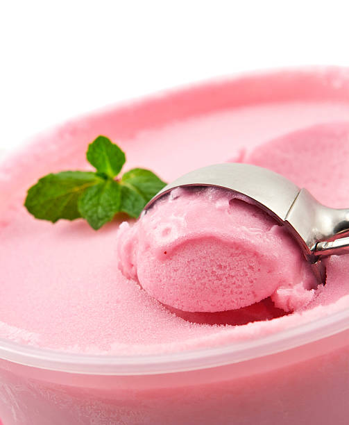 istock Metal spoon scooping raspberry sherbet off a cup 147271550