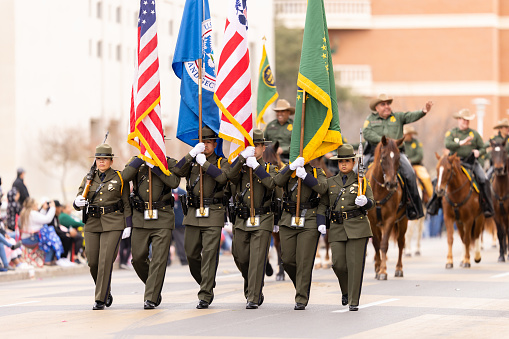 Laredo, Texas, USA - February 19, 2022: The Anheuser-Busch Washingtons Birthday Parade, Members U.S. Border Patrol Escorting the National Flag