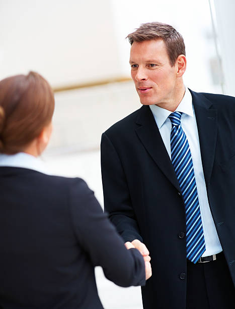 istock Business colleagues shaking hands in an office 147271662