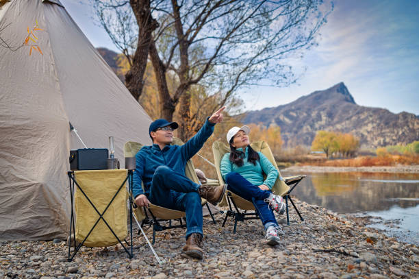 istock Lovers camping by the river in autumn 1472717038