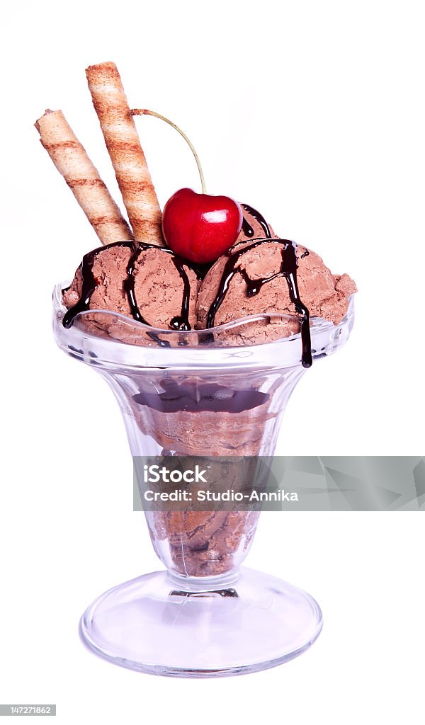 Chocolate ice cream with a wafer and syrup Delicious chocolate ice cream sundae with one red cherry Candy Stock Photo