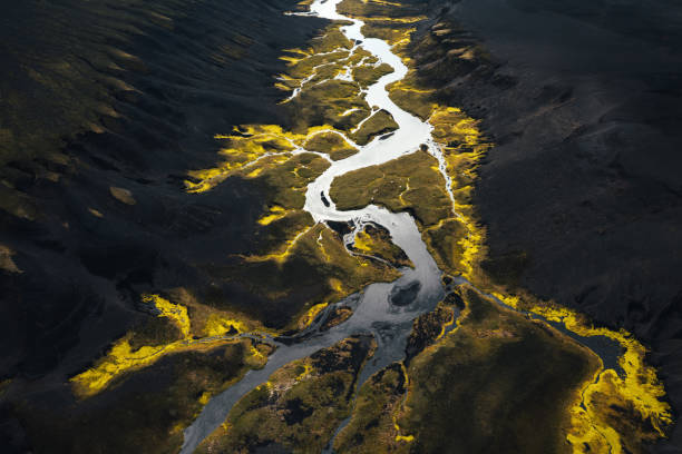 River In Black Sand River flowing through the majestic black Icelandic landscape. grand river stock pictures, royalty-free photos & images