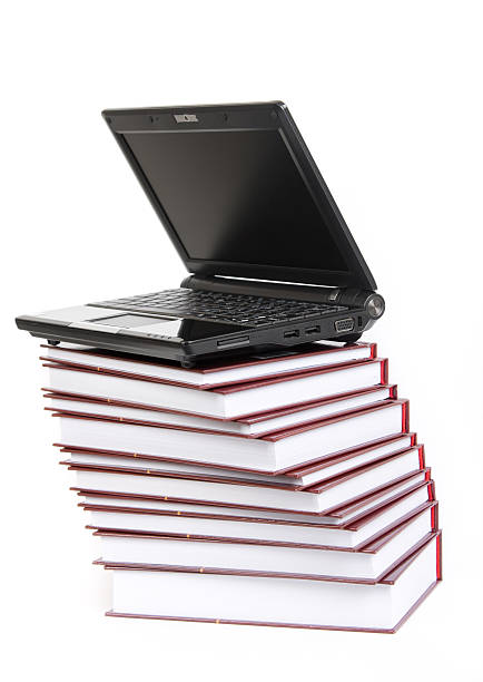 istock laptop on a pile of books 147272065