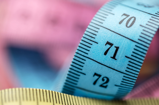 Close-up of a tape measure (different colors). Shallow depth of field, space for copy.
