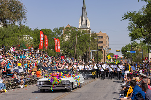 San Antonio, Texas, USA - April 8, 2022: The Battle of the Flowers Parade, Cadillac classic car leading the Consejo del Rey Feo